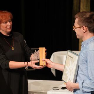 Maxi Gemsjäger nimmt den Ehrenamtspreis für das Kraxlkollektiv entgegen. Foto: DAV/Christine Frühholz