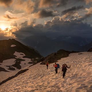 Beim Aufbruch von der Claridenhütte lässt die Morgensonne die Wolken aufleuchten. Foto: Ralf Gantzhorn